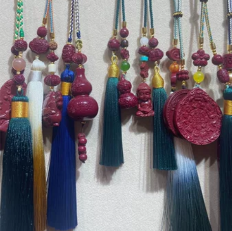 出一款朱砂流苏挂件。该挂件采用彩色丝线制成...