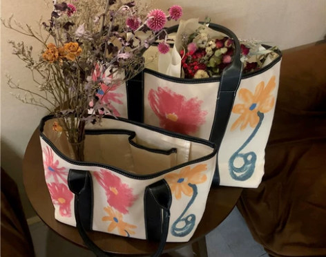 包包女2022新款大容量涂鸦帆布包花朵手提...