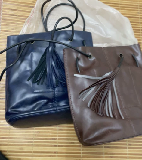 水桶流苏珠子女士斜挎单肩包时尚竖款抽带背包...